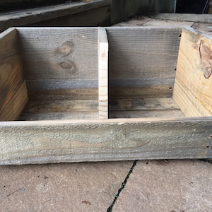 May include: A rustic wooden storage box with two compartments, made from reclaimed wood with a natural gray finish.