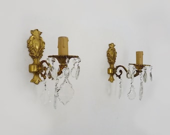 Pair of bronze wall sconces with glass pendants