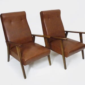 Pair of Scandinavian armchairs in brown leatherette and wood, 1950s-1960s