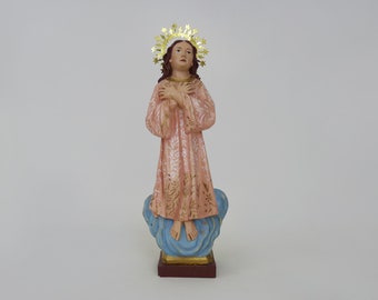 Plaster statue of the Virgin Mary with her hands crossed on her chest. J.M Cosamo 2004