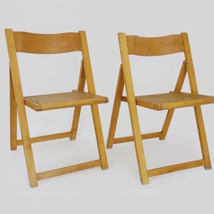 Pair of vintage folding chairs in beech and canework. Italy 70s