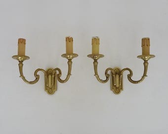 Antique pair of bronze wall sconces with two candles.
