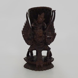 Carved wooden statue of Vishnu riding Garuda. Bali Indonesia. 1930s