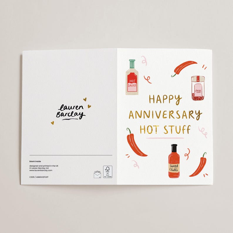 May include: A folded greeting card with a white background. The right side features illustrations of chili peppers, hot sauce bottles, and the text "HAPPY ANNIVERSARY HOT STUFF." The left side has the text "lauren Barclay."