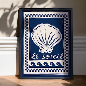 May include: A blue and white framed print featuring a seashell and the text "le soleil" in a decorative font. The print has a checkered border and a wave pattern at the bottom.