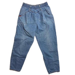 May include: A pair of light blue denim pants with a high waist and a relaxed fit. The pants have a wide leg and a slightly cropped length.