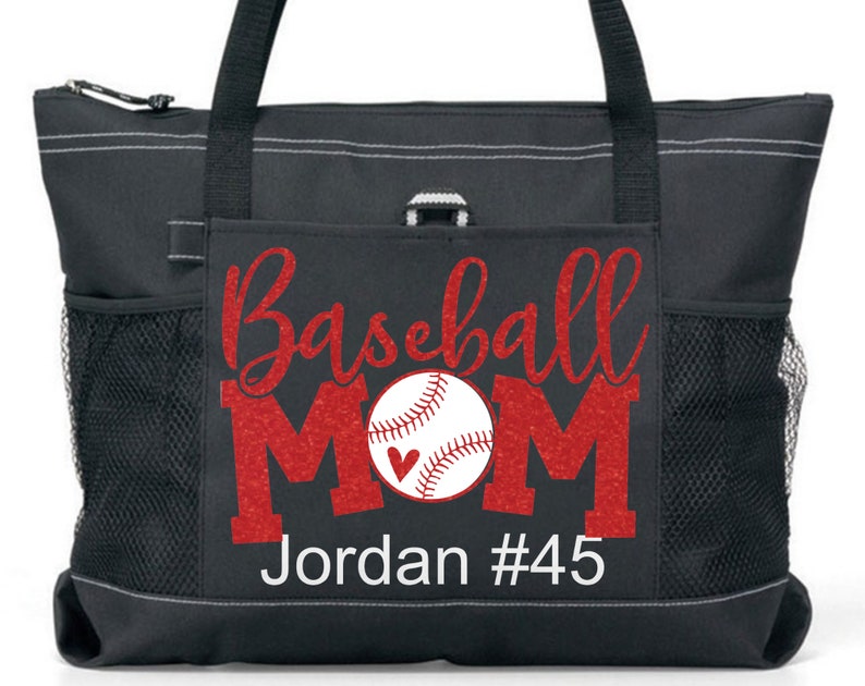 May include: Black tote bag with a red glitter design that says "Baseball Mom" with a baseball and a heart. The bag has a white name tag that says "Jordan #45".