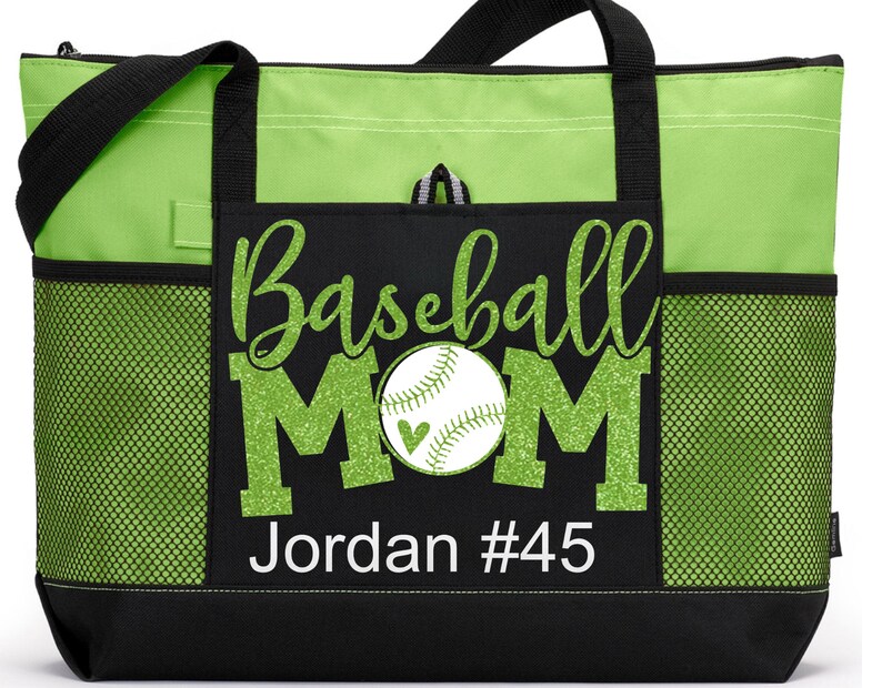 May include: Green and black tote bag with a mesh pocket. The bag has a design that says "Baseball Mom" with a baseball and glitter accents. The text "Jordan #45" is also on the bag.