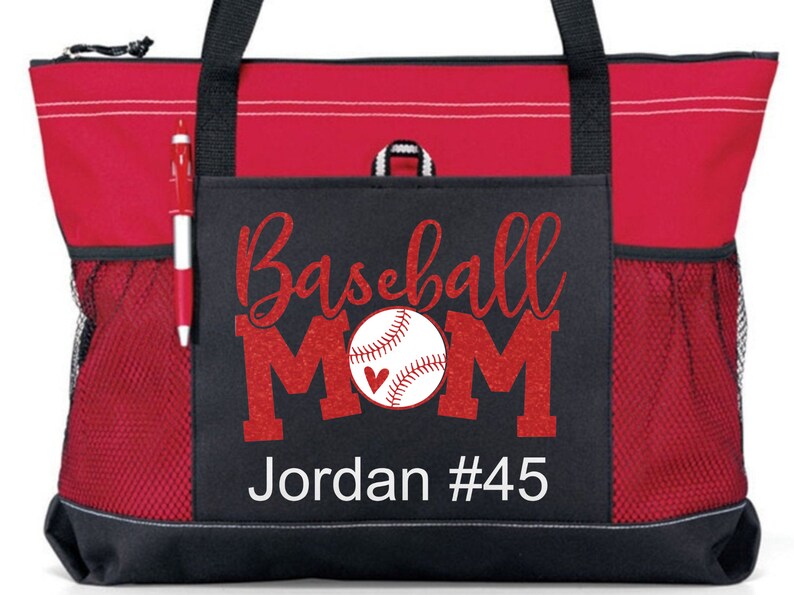 May include: Red and black tote bag with a mesh pocket. The front pocket has a red glitter design that says "Baseball Mom" with a baseball and a heart. The text "Jordan #45" is below the design.