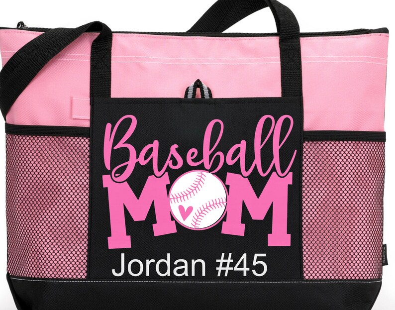 May include: Pink and black tote bag with a mesh pocket. The bag has a pink baseball with a heart on it and the text "Baseball Mom Jordan #45".