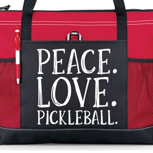 May include: Red and black tote bag with a large white graphic that says "Peace. Love. Pickleball."