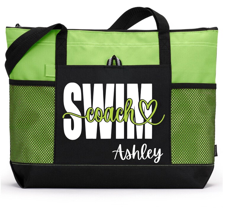 May include: A lime green and black tote bag with the words "SWIM coach" in white and green script, with the name "Ashley" below. The bag has black handles, a black base, and mesh side pockets.