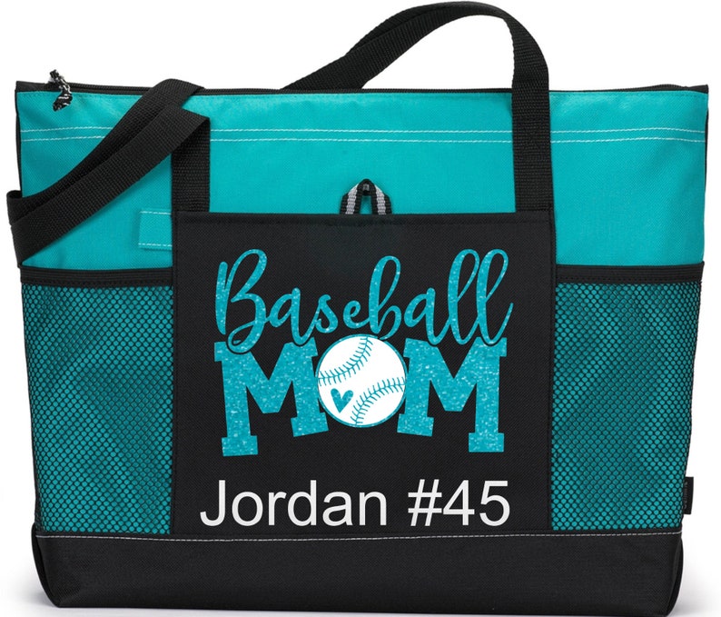 May include: Teal and black tote bag with a mesh pocket. The front pocket has a glittery teal design that says "Baseball Mom" with a baseball and heart. The bottom of the pocket has white text that says "Jordan #45".