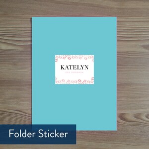 May include: A turquoise blue folder sticker with a white border and pink leopard print. The sticker has the text "KATELYN EVE DONOVAN" in black.