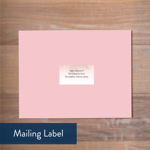 May include: A pink mailing label with a white and grey palm leaf design. The text on the label reads: "Alpha Omicron Pi, 800 Lakeshore Drive, Birmingham, Alabama 35229."