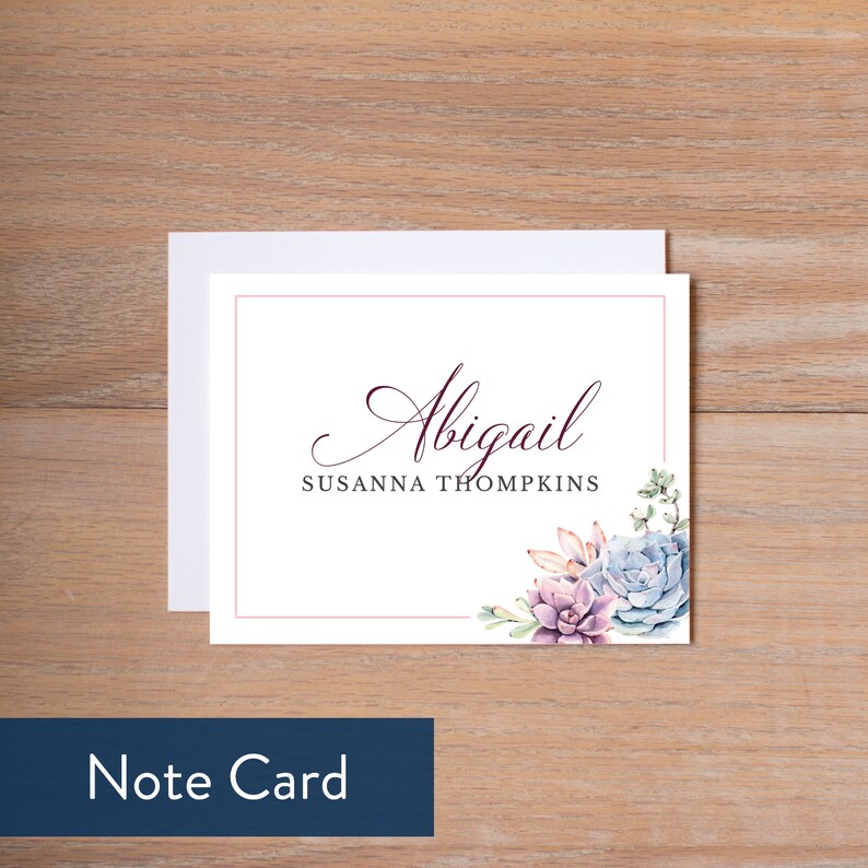 May include: White note card with a pink border and a watercolor illustration of succulents in shades of purple, blue, and green. The text "Abigail Susanna Thompkins" is printed in burgundy.