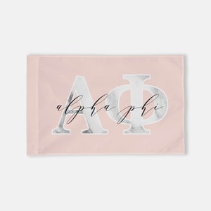 May include: A pink flag with the letters "AΦ" in white with a marble pattern and the words "alpha phi" in black cursive script.