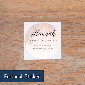 May include: A white round sticker with a pink palm leaf design. The sticker says "Hannah Hannah Woodson Bellevue, Washington Harborview High School" in black text.
