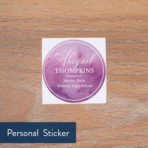 May include: A round, purple watercolor sticker with a white border. The sticker says "Abigail THOMPKINS" in a white cursive font. Below the name, it says "Austin, Texas" and "Waverly High School" in a smaller white font.
