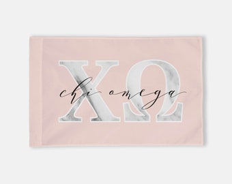 May include: A pink flag with a white marble design featuring the letters "XO" and the text "chi omega" in black cursive.