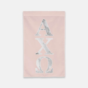 May include: A pink garden flag with the letters AXQ in white with a marble pattern.