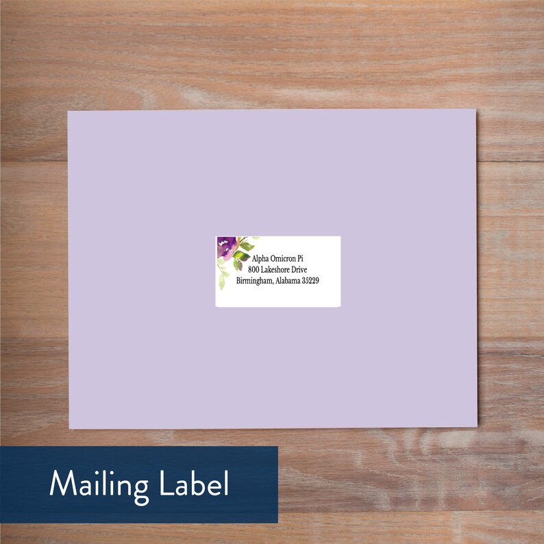 May include: A purple and green floral design adorns a white mailing label with the text "Alpha Omicron Pi, 800 Lakeshore Drive, Birmingham, Alabama 35229".