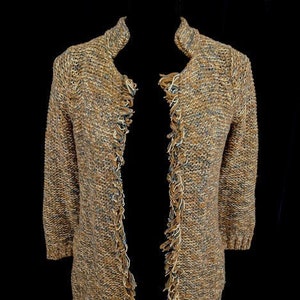 May include: A long-sleeved cardigan with a brown, beige, and blue color scheme. The cardigan has a fringed trim along the edges and a slightly open front.
