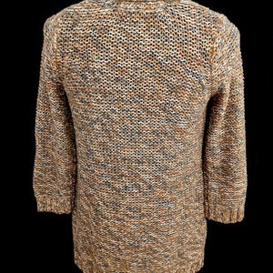May include: A brown and blue knitted cardigan with a long sleeve and a v-neck.