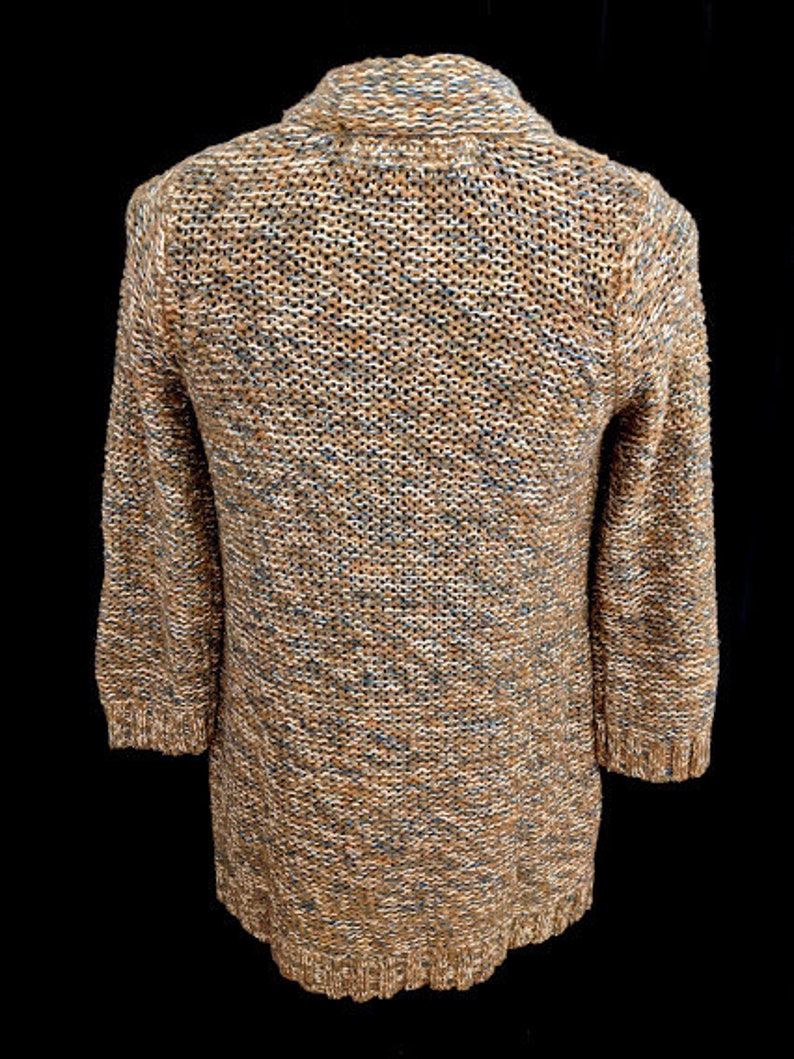 May include: A brown and blue knitted cardigan with a long sleeve and a v-neck.