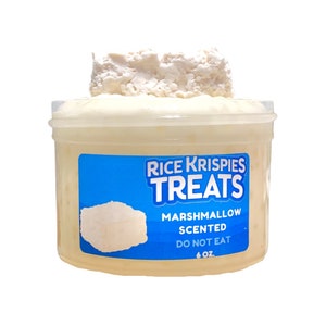 May include: A clear plastic container filled with a white, fluffy slime. The container has a blue label that reads "Rice Krispies Treats Marshmallow Scented Do Not Eat 6 oz."