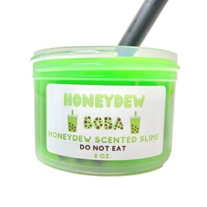 May include: A green slime in a clear plastic container with a white label that says "Honeydew Boba" and "Honeydew Scented Slime Do Not Eat 6 oz."
