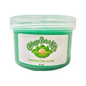 May include: A green, 6 oz. jar of unscented slime with a Cabbage Patch Kids logo. The logo features a Cabbage Patch Kid doll with a green cabbage leaf.