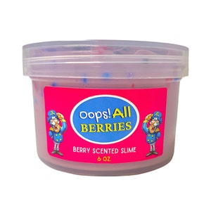 May include: A clear plastic container filled with pink slime, speckled with blue and red dots. A bright pink label features the text "Oops! All BERRIES" and "Berry Scented Slime". The container holds 6 oz of slime.