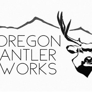 May include: Black and white logo for Oregon Antler Works. The design features a stylized deer head with large antlers, mountains, and the company name in a clean, sans-serif font.