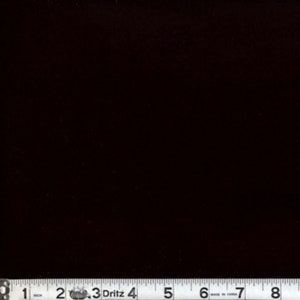 Pode incluir: Uma amostra de tecido preto com uma fita métrica mostrando 8 polegadas.