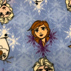 May include: Blue fabric with a repeating pattern of white snowflakes and images of characters from the movie Frozen. The characters include Elsa, Anna, and Olaf.
