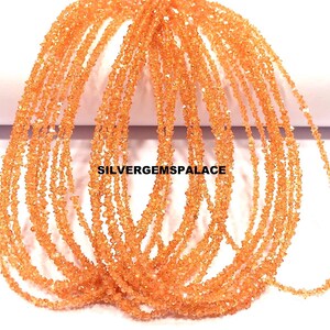 May include: Strands of orange gemstone beads. The beads are small, irregular chips, creating a textured appearance. The strands are arranged in a cascading pattern, with the text "SILVERGEMSPALACE" visible.