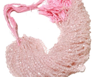 May include: A strand of pale pink rose quartz beads, approximately 4 mm in size, with a faceted finish. The beads are strung on a pink thread and are ready to be used for jewellery making.