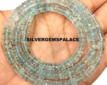 May include: Strands of light blue aquamarine gemstone beads. The beads are small, rectangular, and strung together. The text "SILVERGEMSPALACE" is visible. The beads are displayed against a skin-toned background.