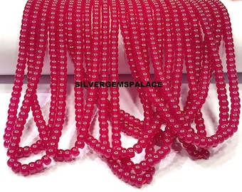 May include: Strands of bright red, round beads. The beads are strung together, creating multiple lines of the same product. The text "SILVERGEMSPALACE" is visible in the image. These beads could be used for jewelry making.