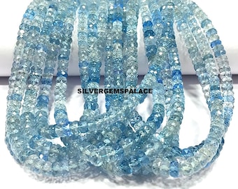May include: Strands of faceted aquamarine beads in varying shades of blue and clear. The beads are strung together, creating a layered effect. The image is well-lit, showcasing the gemstone's clarity and color. The text "SILVERGEMSPALACE" is visible.