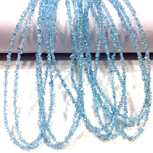 May include: A strand of light blue gemstone beads, each bead is faceted and has a pointed shape. The beads are strung on a clear thread and are approximately 4mm in diameter.