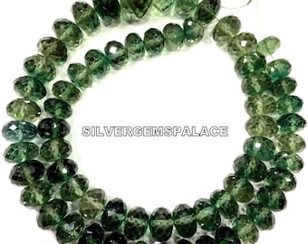 May include: A strand of green gemstone beads, faceted and oval shaped. The beads are strung on a thin wire and are approximately 10mm in diameter. The beads are a mix of light and dark green shades. The image includes the text "SILVERGEMSPALACE".