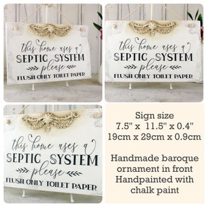 May include: White wooden sign with a baroque-style ornament. The sign reads "This home uses a septic system please flush only toilet paper". The sign measures 7.5 inches by 11.5 inches by 0.4 inches.