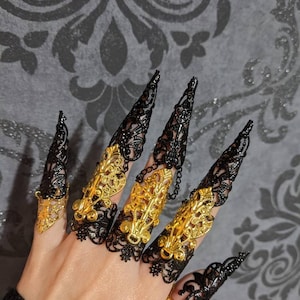 Two hands armors and 10 black and gold articulated full finger rings with long claw nail rings (Full set).