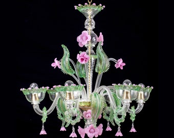 May include: A glass chandelier with pink and green floral accents. The chandelier has five lights and is made of clear glass.