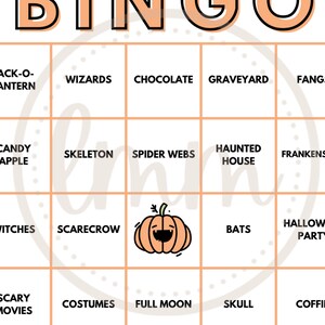 May include: A Halloween-themed bingo card with a peach-colored background and orange text. The bingo card features Halloween-related words and images, including a jack-o'-lantern, witches, and bats. The word "BINGO" is at the top.