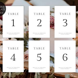 May include: Six white rectangular table number cards labelled 1 through 6 in black serif font. Each card features the text TABLE, the number, and the names BELLA & EDWARD with the date SATURDAY SEPTEMBER 17 printed in a smaller font below.