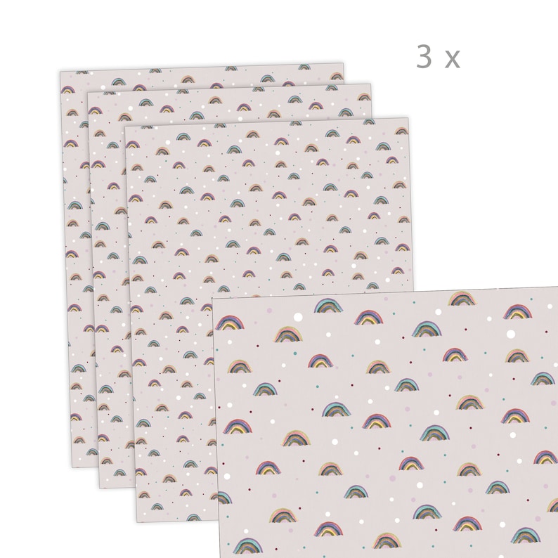 May include: A pack of three sheets of wrapping paper with a rainbow and polka dot pattern. The paper is light pink with small white polka dots and a repeating pattern of multi-colored rainbows.