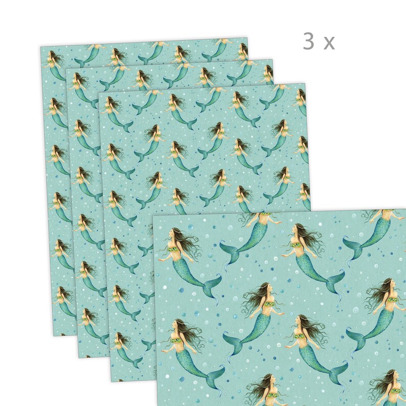 May include: A set of three turquoise blue wrapping paper sheets with a repeating pattern of mermaids with green tails and white shells. The mermaids are swimming in a sea of white bubbles.